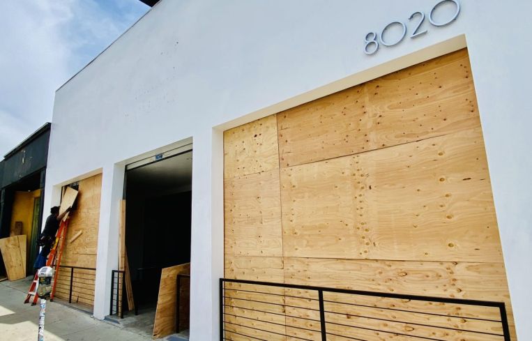 A vacant retail property is boarded up on Melrose Avenue in Los Angeles during the recent civil unrest.