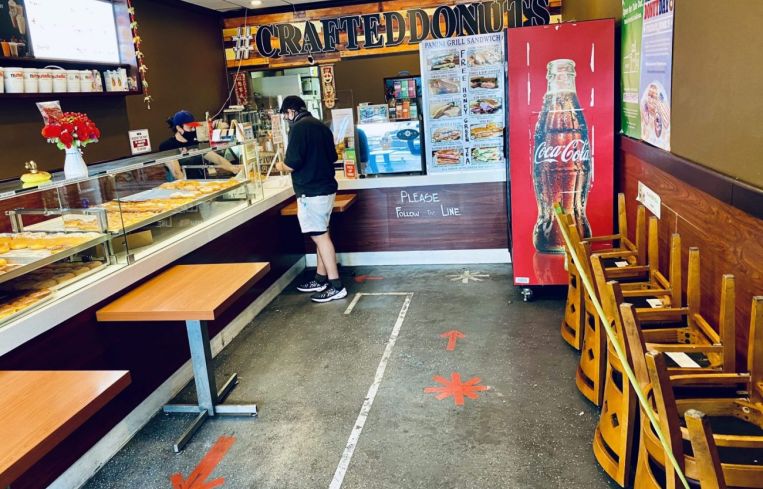 Shelter-in-place and social distancing orders led to massive layoffs and furloughs throughout California and Los Angeles. Above, Crafted Donuts on Wilshire Boulevard in L.A.