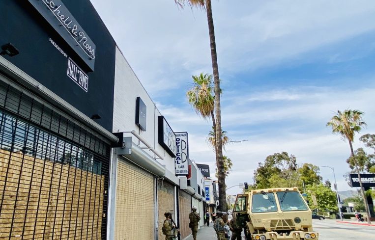Mitchell & Ness and a row of other retailers on Fairfax have been boarded up.