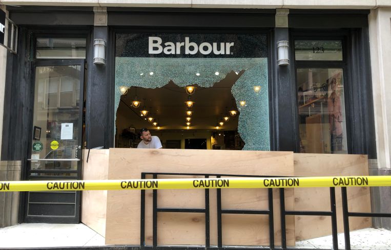 The exterior of a damaged Barbour store.
