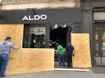 Workers board up a damaged Aldo store on Broadway in the wake of the May 31 George Floyd/Black Lives Matter protests.