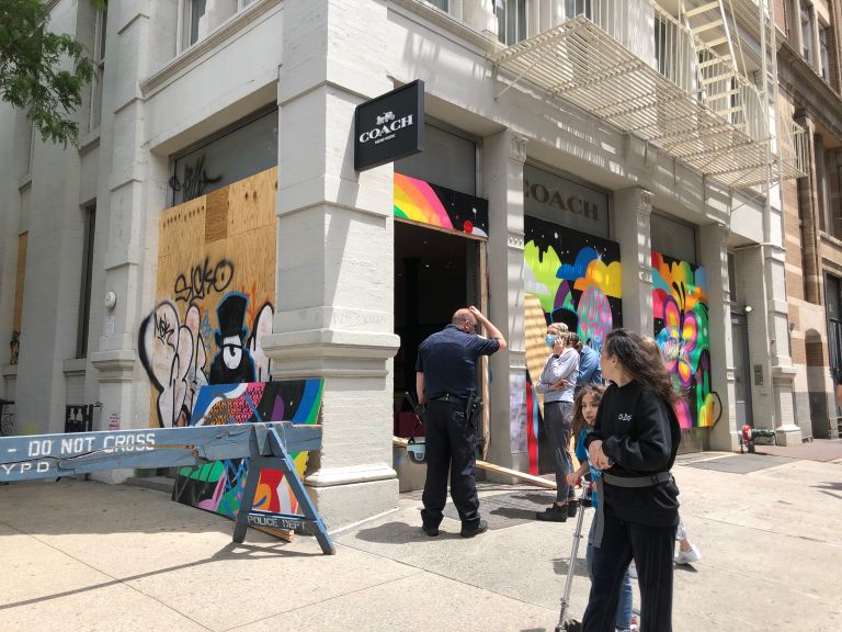 A Louis Vuitton retail store on Fifth Avenue is boarded up after a long  night of unrest in Manhattan as protests, looting and rioting around the  country continue over the death of