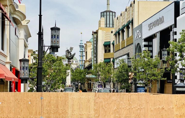 Wood walls put up separating from the destruction at The Grove.