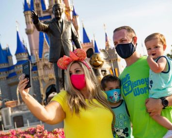Guests stop to take a selfie at Magic Kingdom Park at Walt Disney World Resort on July 11, 2020 in Lake Buena Vista, Florida.