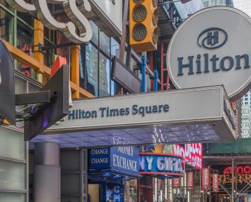A colorful, busy hotel entrance on a sidewalk.