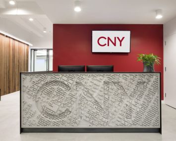 CNY Group designed a concrete reception desk that's been stamped with an aerial map of Midtown Manhattan and the company's name.