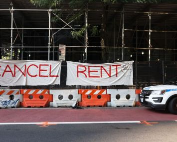 A banner sign on scaffolding that says "cancel rent."