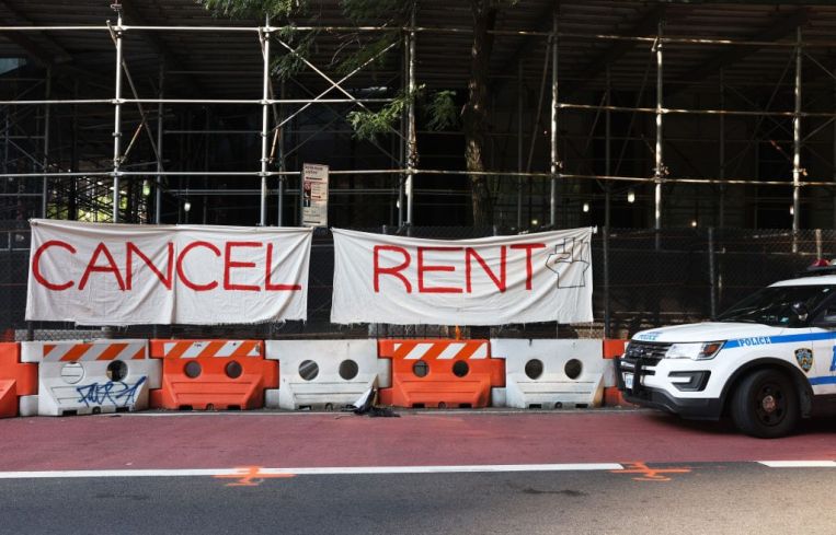 A banner sign on scaffolding that says "cancel rent."