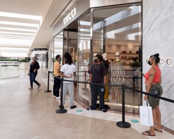 Customers wait online in South Coast Plaza mall