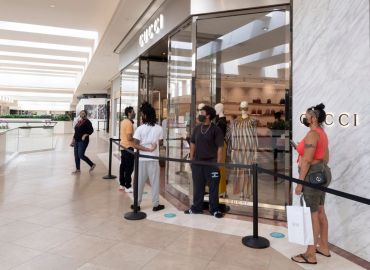 Customers wait online in South Coast Plaza mall