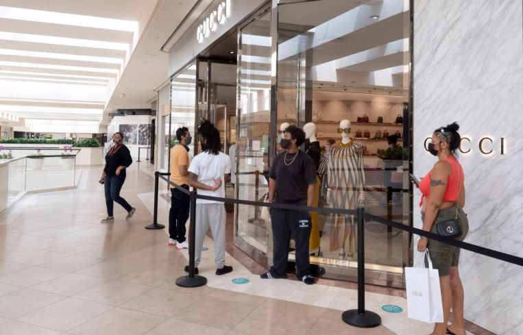 Customers wait online in South Coast Plaza mall