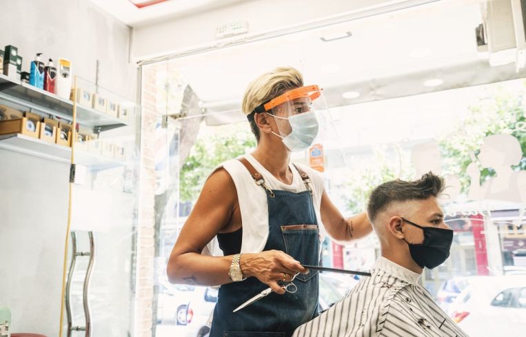 Barbershops and hair salons must practice physical distancing and use face coverings for both employees and customers.