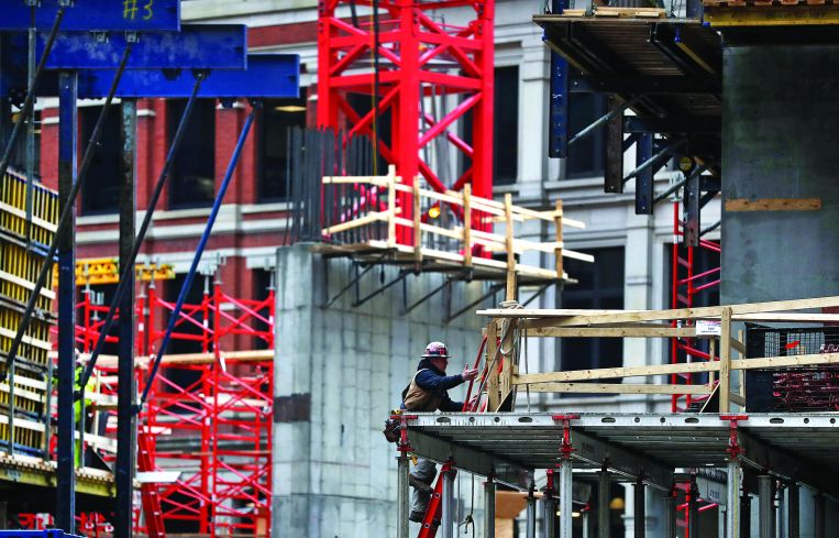 A construction worker on a construction site for a tall building.