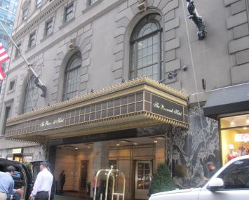 Entrance of a glitzy hotel on a sidewalk.
