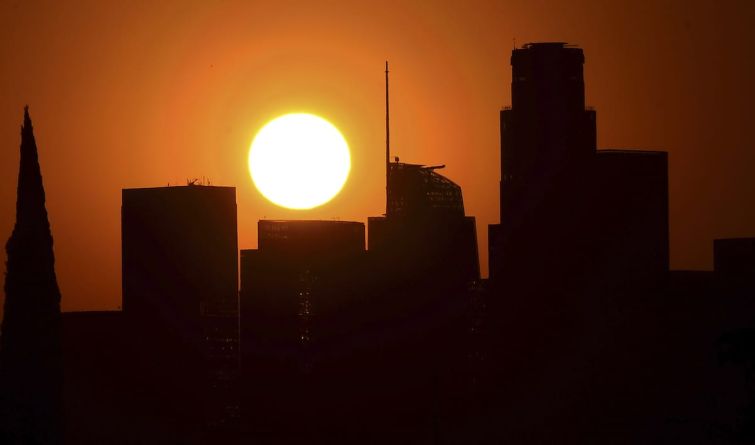 The sun sets behind Downtown Los Angeles on September 30. Third quarter office leasing dropped 18 percent from the second quarter.