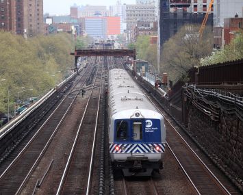 A lone train down a set of tracks.