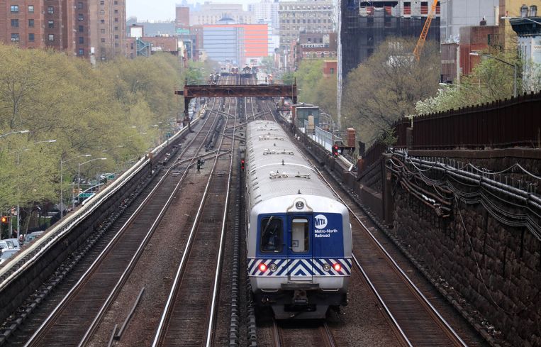 A lone train down a set of tracks.