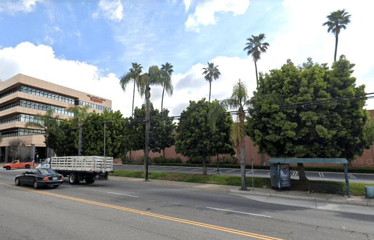 Amazon will demolish the printing plant next to the five-story office to the left, which is still available for sale or lease via developer Michael Harrah.