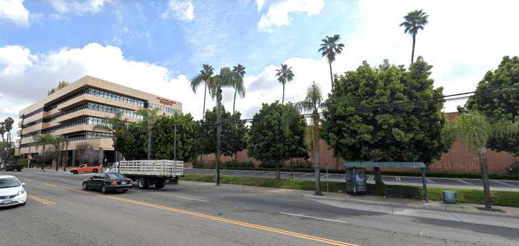 Amazon will demolish the printing plant next to the five-story office to the left, which is still available for sale or lease via developer Michael Harrah.