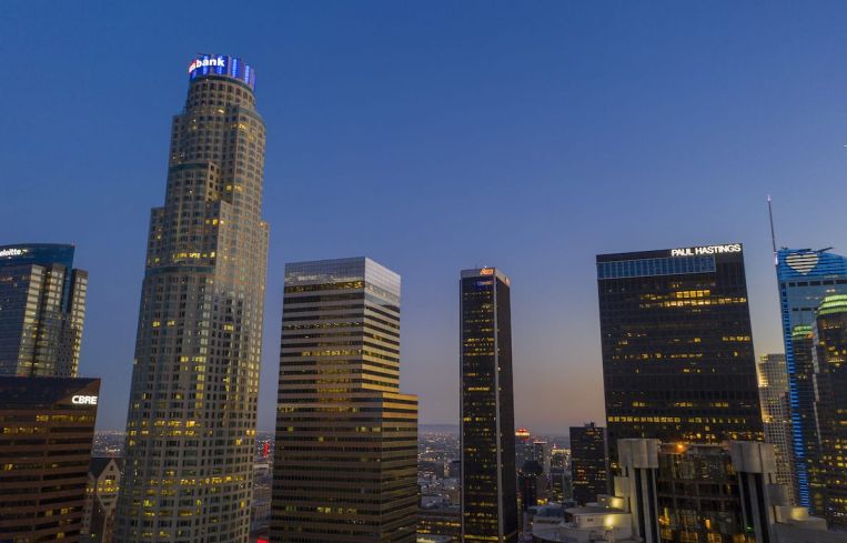 The U.S. Bank Tower, left seen in Downtown Los Angeles in May, shortly before it sold to Silverstein Properties. The tower and other high-rise office buildings have been absent more often than filled with workers since March when Gov. Gavin Newsom ordered Californians to stay home during the coronavirus (COVID-19) pandemic.