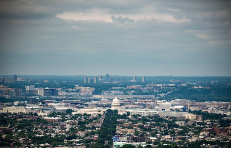 Aerial view of a large metro region with a dome in the middle.