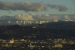 Snow-topped mountains stand behind the Hollywood Hills following heavy rains as seen from the Kenneth Hahn State Recreation Area on December 29.