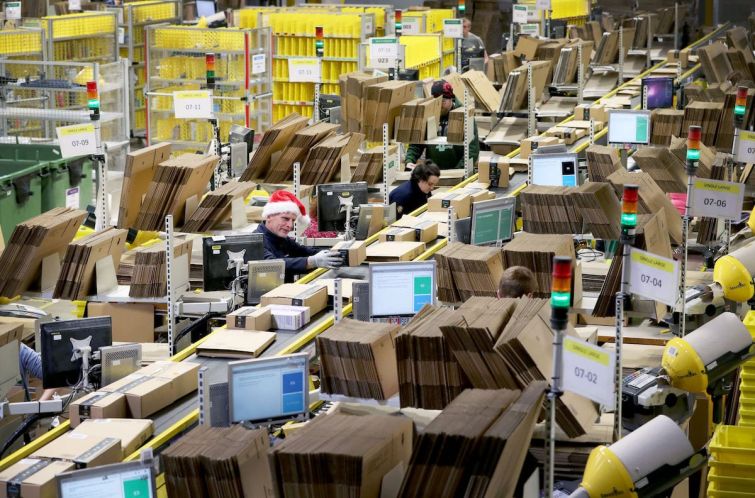Staff label and package items in the on-site dispatch hall inside one of Amazon's warehouses, as the online shopping giant gears up for the Christmas rush.