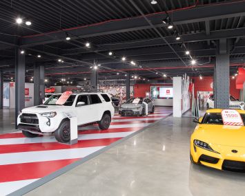 A cavernous room with cars.
