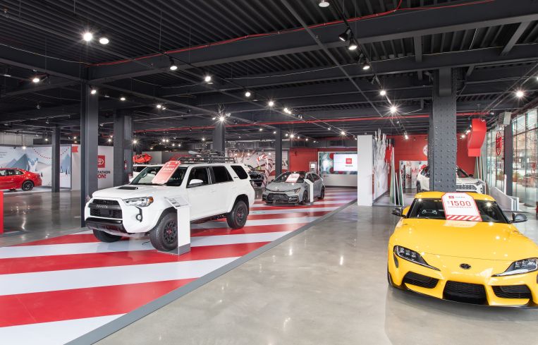 A cavernous room with cars.