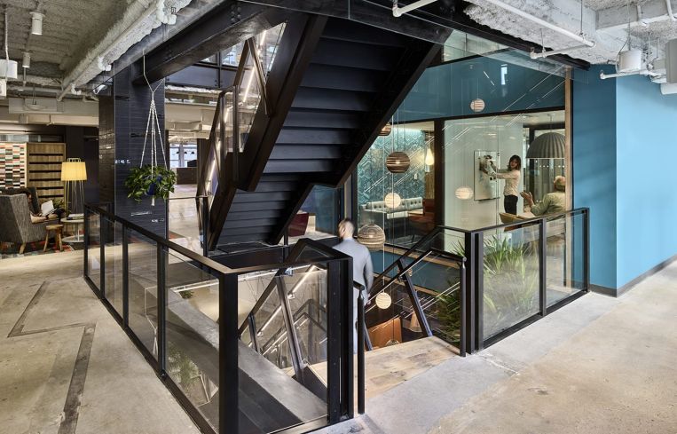 A large open staircase connects all five floors.