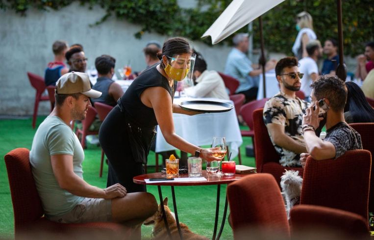 People have drinks and dine on the outdoor patio at La Boheme in West Hollywood. With the stay-at-home order lifted, restaurants to restart outdoor dining.