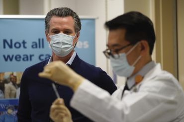 Gov. Gavin Newsom watches as the Pfizer-BioNTech COVID-19 vaccine is prepared by Director of Inpatient Pharmacy David Cheng at Kaiser Permanente Los Angeles Medical Center. Newsom and legislative leaders said “work is far from over" for protecting renters in the state.