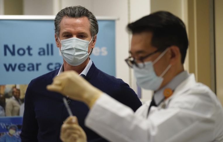 Gov. Gavin Newsom watches as the Pfizer-BioNTech COVID-19 vaccine is prepared by Director of Inpatient Pharmacy David Cheng at Kaiser Permanente Los Angeles Medical Center. Newsom and legislative leaders said “work is far from over" for protecting renters in the state.