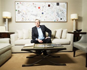 A man sitting on a couch in an office.