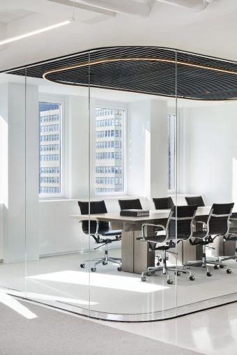 A conference room was encased in rounded glass to let in as much light as possible.