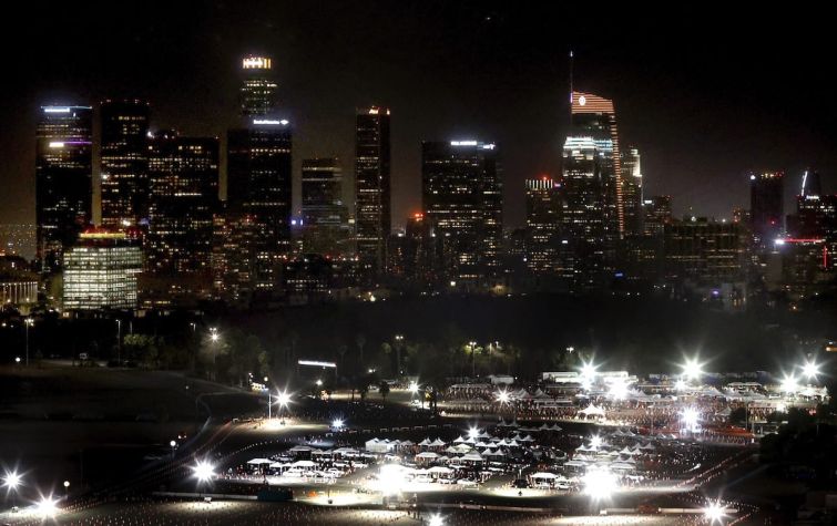 The Dodger Stadium testing and vaccination site overlooked by Los Angeles' skyline.