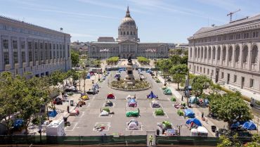 Squares painted on the ground to encourage homeless people to keep to social distancing at a city-sanctioned homeless encampment across from City Hall in San Francisco in 2020, amid the novel coronavirus pandemic.