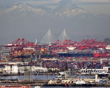 Container ships and at the Port of Los Angeles with the Port of Long Beach in the distance in February 2021. A record number of container ships are on standby to offload cargo to the ports amid a wave of online consumer purchases in the U.S. amid the pandemic.