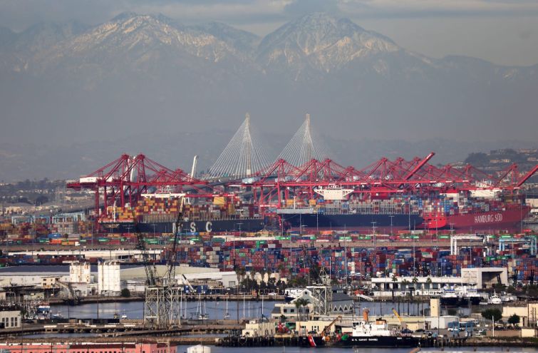 Container ships and at the Port of Los Angeles with the Port of Long Beach in the distance in February 2021. A record number of container ships are on standby to offload cargo to the ports amid a wave of online consumer purchases in the U.S. amid the pandemic.