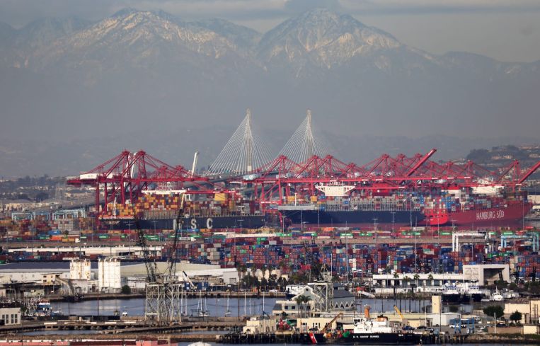 Container ships and at the Port of Los Angeles with the Port of Long Beach in the distance in February 2021. A record number of container ships are on standby to offload cargo to the ports amid a wave of online consumer purchases in the U.S. amid the pandemic.