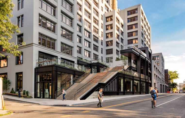 A mid-rise building with a giant exterior staircase.