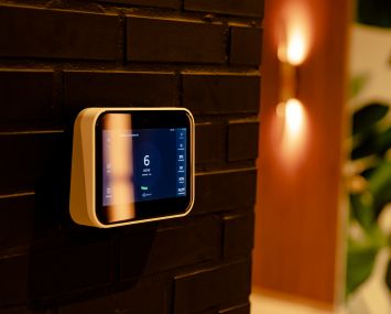 A monitor mounted on a wall with the number 6 displayed on it.