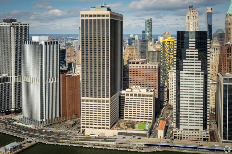 A wide view of buildings along a waterfront.
