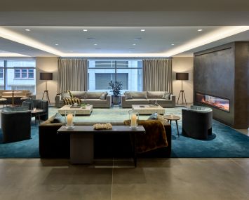 The new 11,000-square-foot amenity center at 100 Park Avenue, designed by Design Republic, includes several different areas, including a lounge space with midcentury modern-inspired furniture.