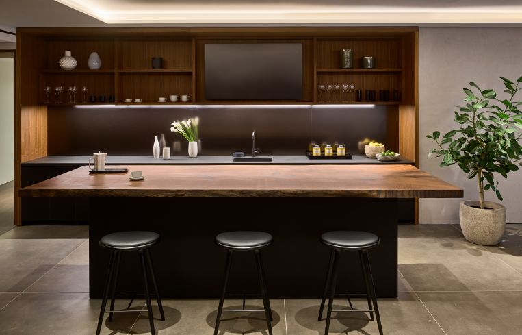There is also a midcentury-style pantry with walnut shelving and a bar-height counter.