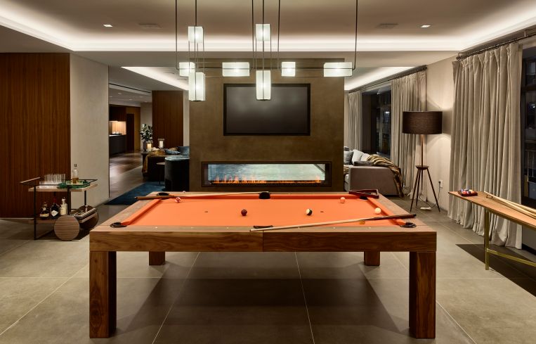 The game room with a pool table just beyond the wall.