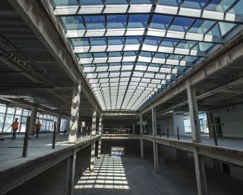 Workers sweep inside the newly added 3rd floor of the vacant Sears store in Santa Monica that has recently undergone a $50 million makeover to turn the Art Deco-style building into an office, restaurant and retail complex.