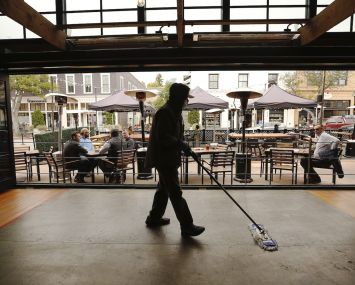 Part of the sanitation team cleaning a restaurant as they prepare to open for indoor dinning. In the "red tier," counties are allowed to reopen indoor dining and gyms.