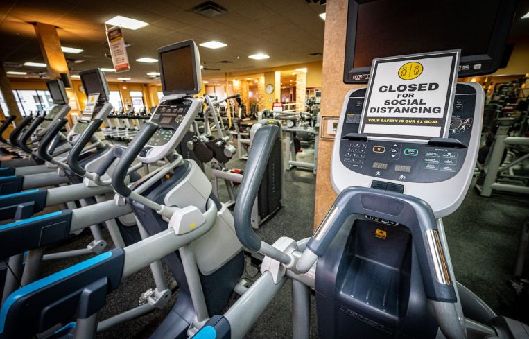 Signs are posted for social distancing on machines throughout the facility. Gyms are still currently closed for indoor operations in Southern California.