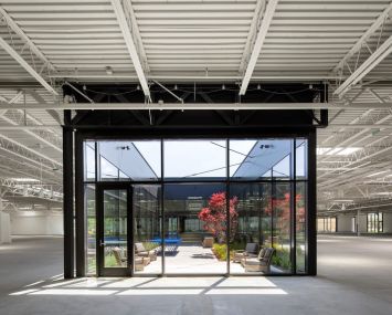 The creative office at 555 Aviation Boulevard features a fitness center, coffee shop, and outdoor lounge areas.